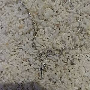 Gun with hand cuffs necklace